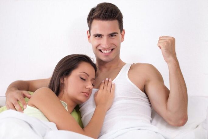 a woman in bed with a man with increased potency